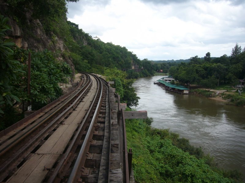 Death train tracks over a rickety bridge by the river kwai.